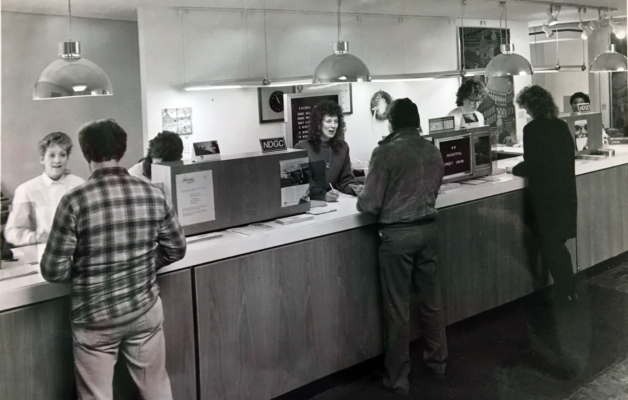 Image: Old photo of members transacting in Elyria office